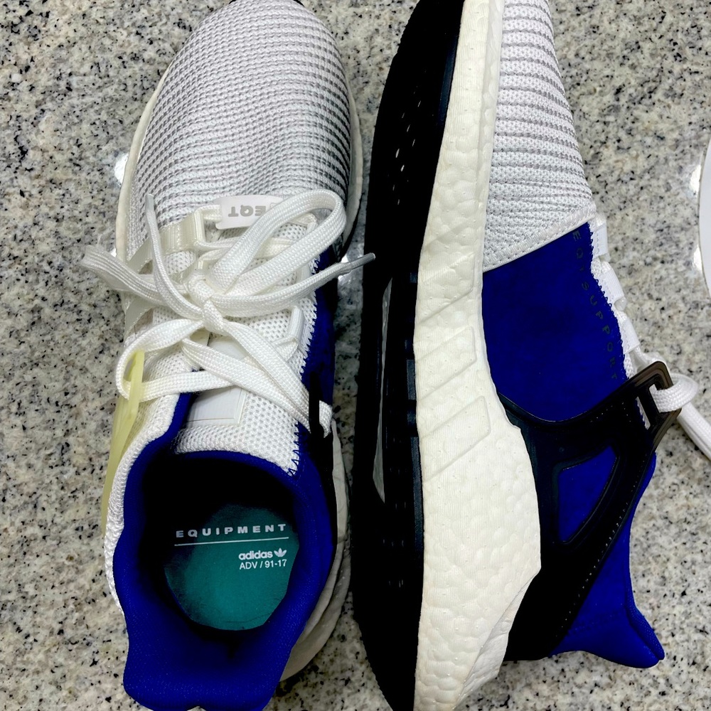White and blue Adidas tennis shoes
